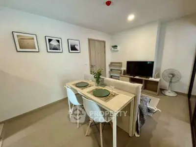 Modern living room with dining area, stylish decor, and cozy ambiance in a contemporary apartment.
