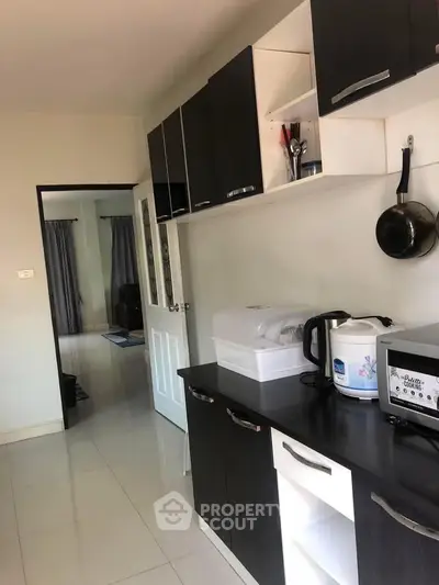 Modern kitchen with sleek black cabinets and appliances