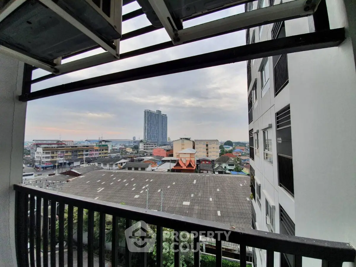 Stunning cityscape view from a modern apartment balcony with urban skyline.