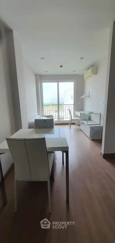 Modern living room with minimalist furniture and large window view.