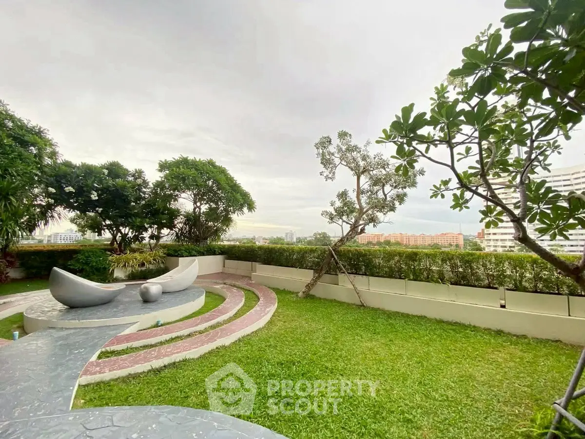 Stunning rooftop garden with modern seating and lush greenery, offering a serene escape with city views.