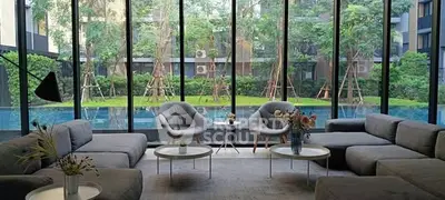 Luxurious living room with pool view and modern furniture in upscale residence.