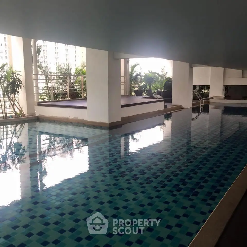 Luxurious indoor swimming pool with modern design and city view, perfect for relaxation and leisure.