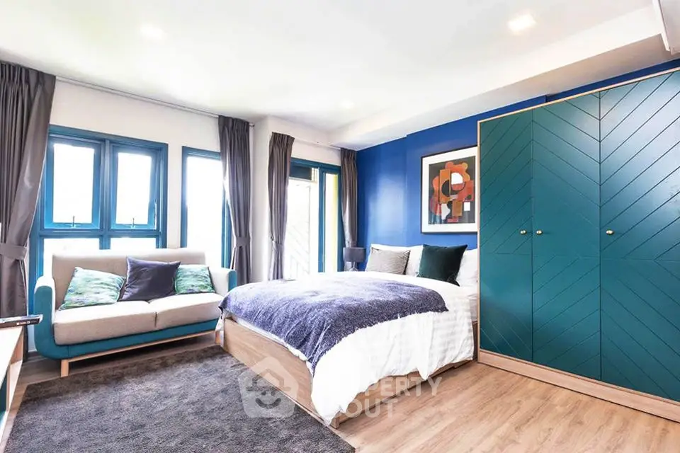 Spacious modern bedroom with stylish decor and natural light