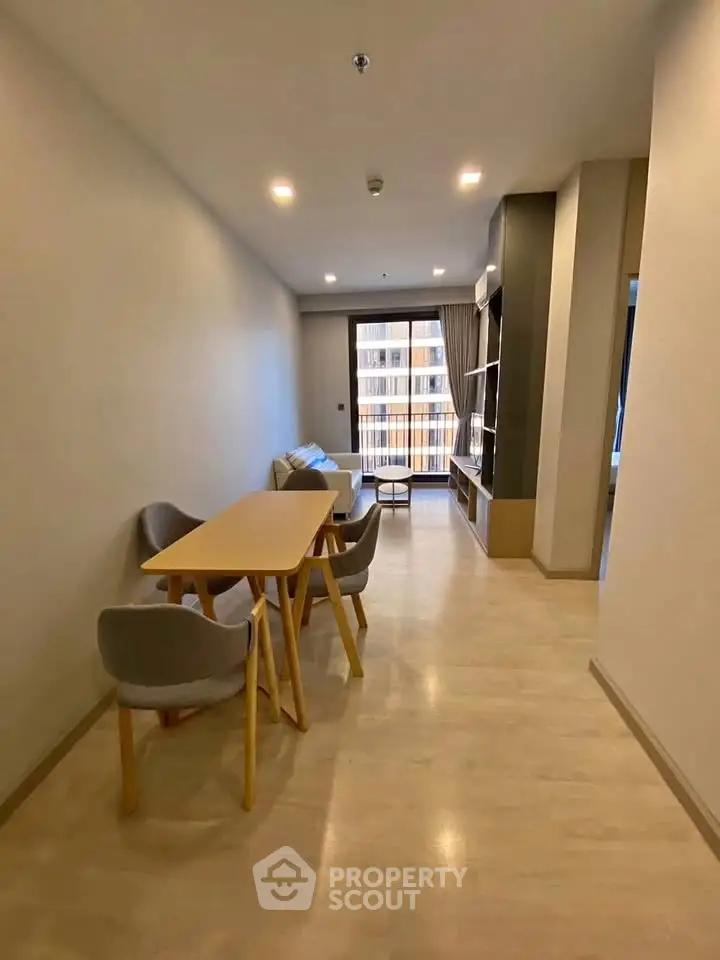Modern living room with dining area and natural light