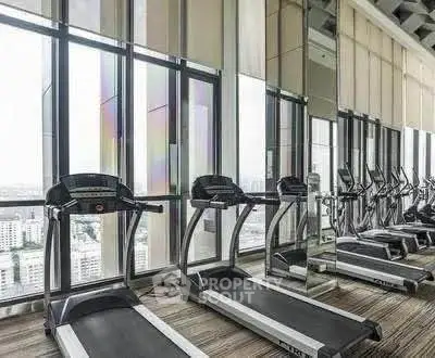 Modern high-rise gym with city view and state-of-the-art equipment.
