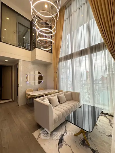 Luxurious modern living room with high ceilings and elegant decor in a city apartment.