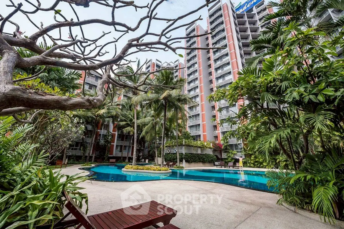 Luxurious apartment complex with pool and lush garden, perfect for relaxation and modern living.