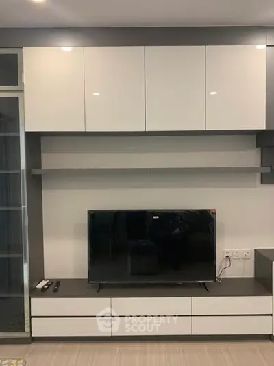 Modern living room with sleek TV unit and storage cabinets