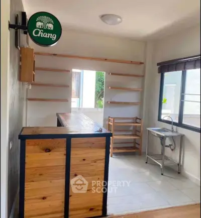 Charming kitchen with wooden bar and open shelving, perfect for modern living.