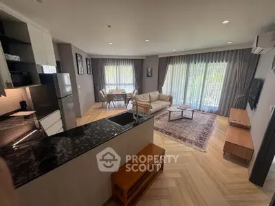 Spacious open-plan living room with modern kitchen and elegant decor