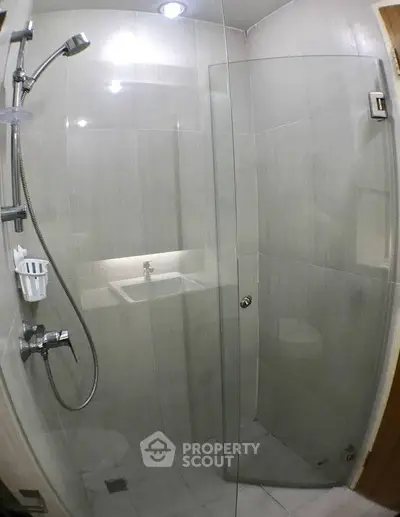 Modern bathroom with glass shower enclosure and sleek fixtures