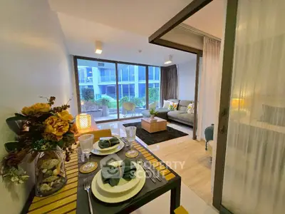Modern living room with elegant dining setup and large windows overlooking a garden view.