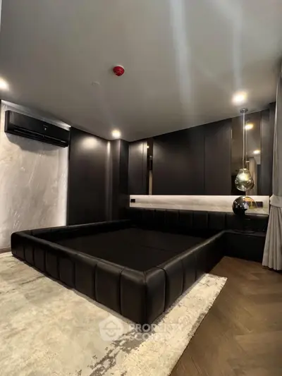 Luxurious modern bedroom with sleek black furniture and ambient lighting