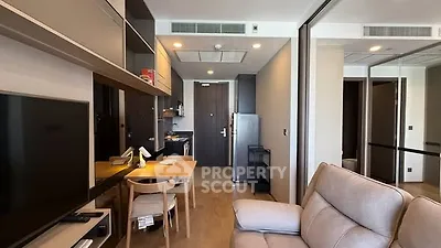 Modern apartment interior with cozy living area and compact kitchen
