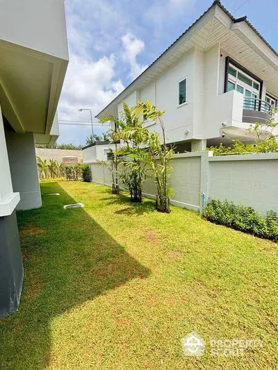 Spacious garden area with lush greenery and modern home exterior