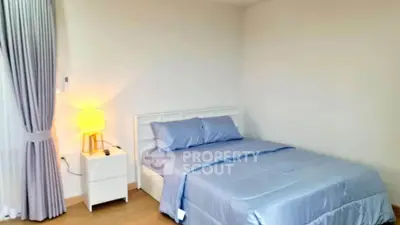 Cozy bedroom with soft lighting and modern decor, perfect for relaxation and comfort.