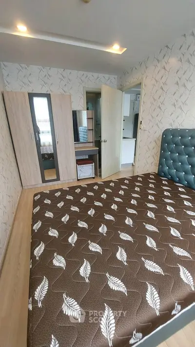 Cozy bedroom with stylish decor and ample storage space in modern apartment.