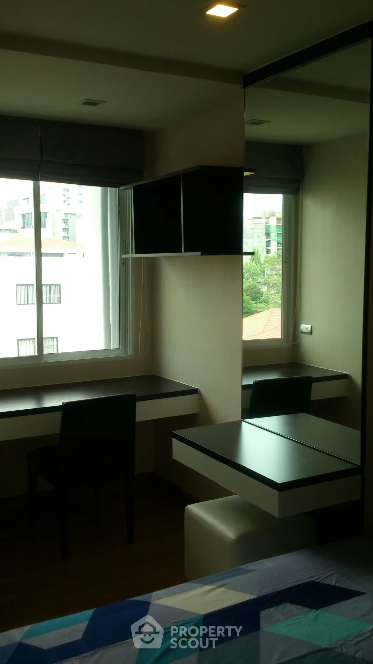 Modern bedroom with sleek desk and large window view