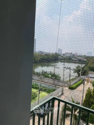 Scenic balcony view overlooking a serene river and lush greenery.