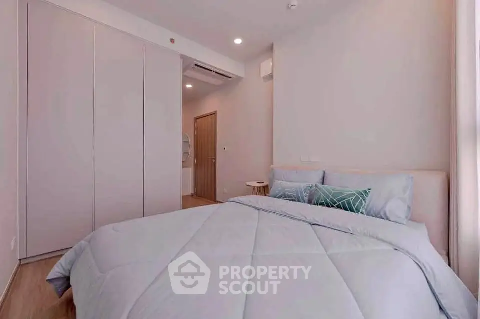 Modern bedroom with sleek design and ample storage in a stylish apartment.