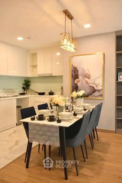 Elegant dining area with modern kitchen, stylish decor, and ambient lighting