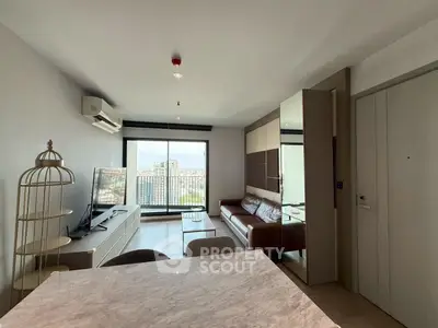 Modern living room with city view, featuring sleek furniture and large windows.