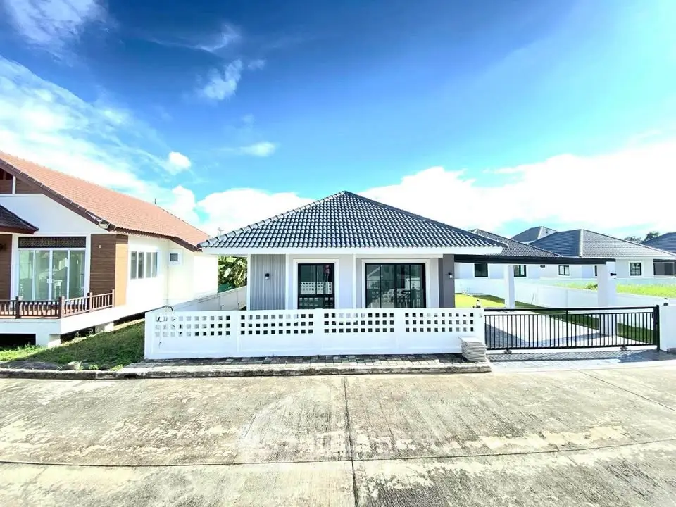 Charming single-story house with modern design and spacious driveway in a serene neighborhood.