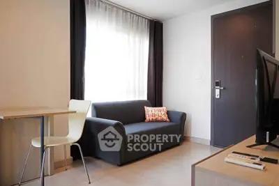 Modern living room with sleek furniture and natural light, perfect for urban living.