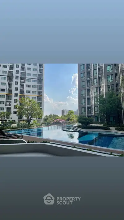 Luxurious condominium pool area with stunning city view and modern architecture.