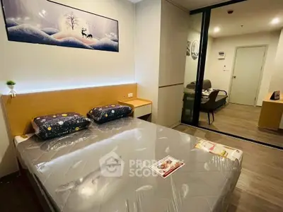 Modern bedroom with stylish decor and sliding glass doors leading to a cozy living area.