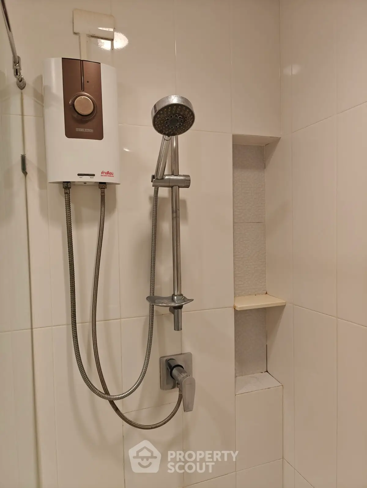 Modern bathroom with sleek shower and water heater in a contemporary design.