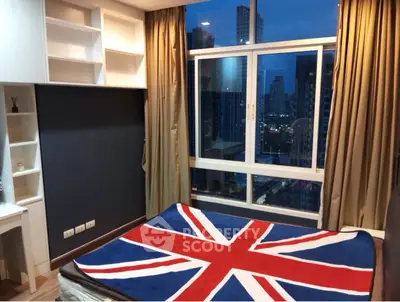Modern bedroom with city view and Union Jack themed bedding