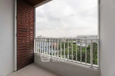 Spacious balcony with city view and safety netting, perfect for relaxation.