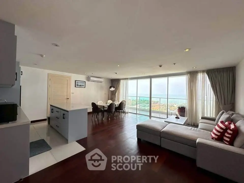 Spacious living room with panoramic view and modern furnishings in a luxury apartment.