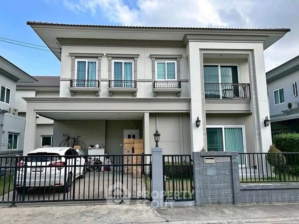 Elegant two-story house with modern facade and spacious driveway in a serene neighborhood.