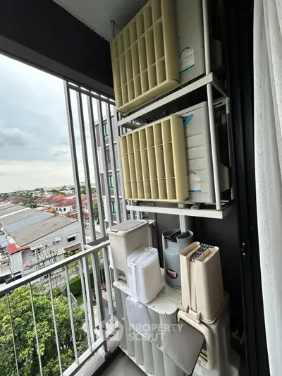 Compact balcony with air conditioning units and city view, ideal for urban living.