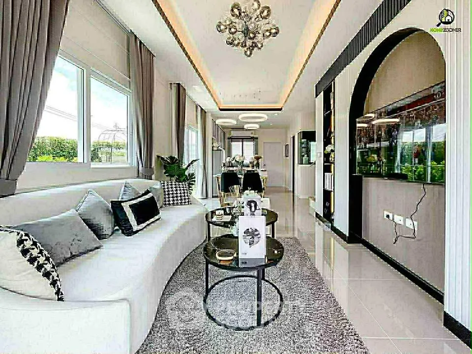 Luxurious modern living room with elegant decor and large windows offering natural light