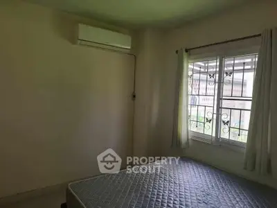 Cozy bedroom with air conditioning and window view