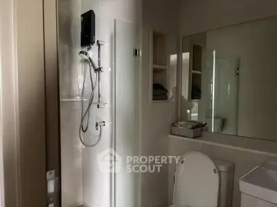 Modern bathroom with sleek shower and large mirror, perfect for contemporary living.