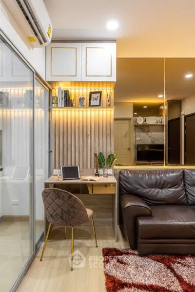 Modern living room with stylish decor, leather sofa, and cozy workspace in a contemporary apartment.