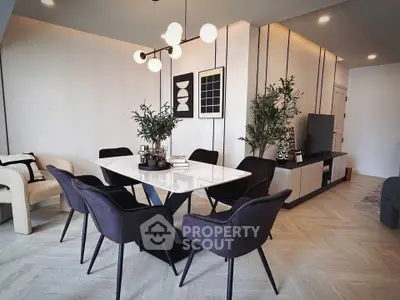 Modern dining area with elegant decor and stylish lighting in a contemporary apartment.