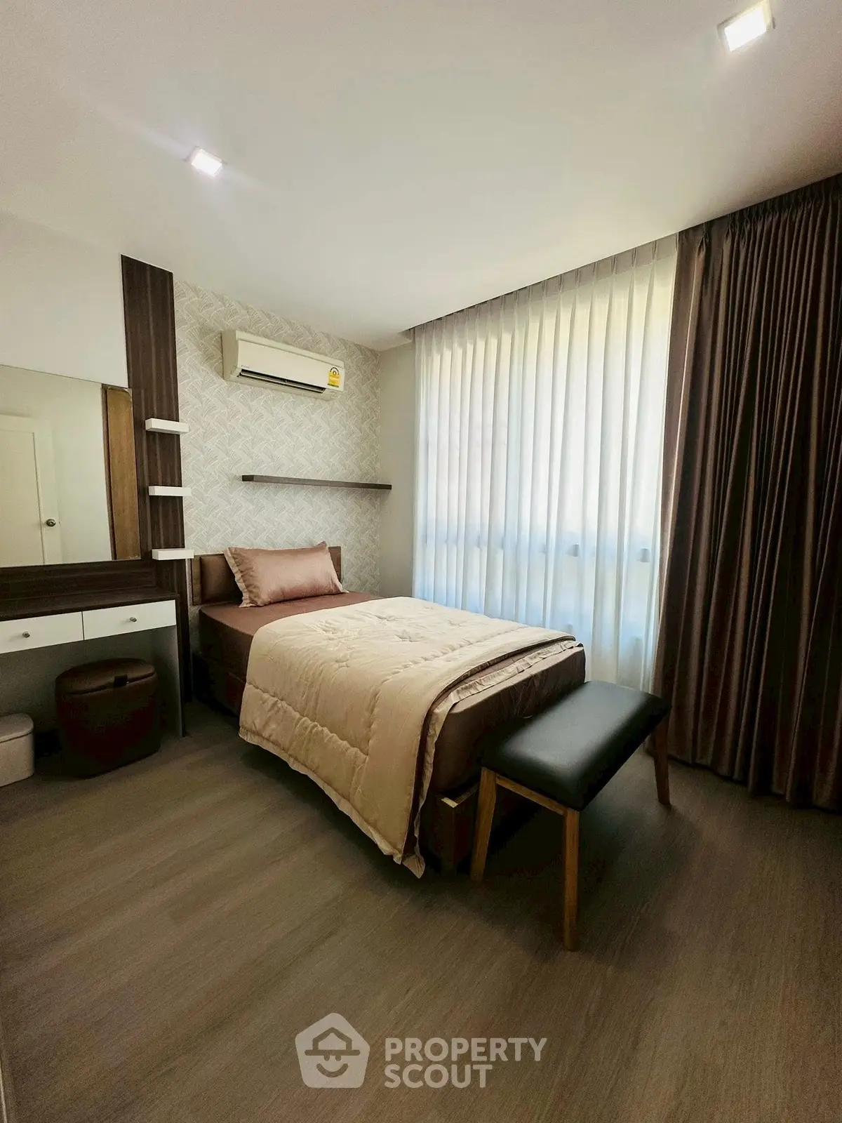 Cozy bedroom with modern decor, featuring a single bed, stylish curtains, and ample natural light.