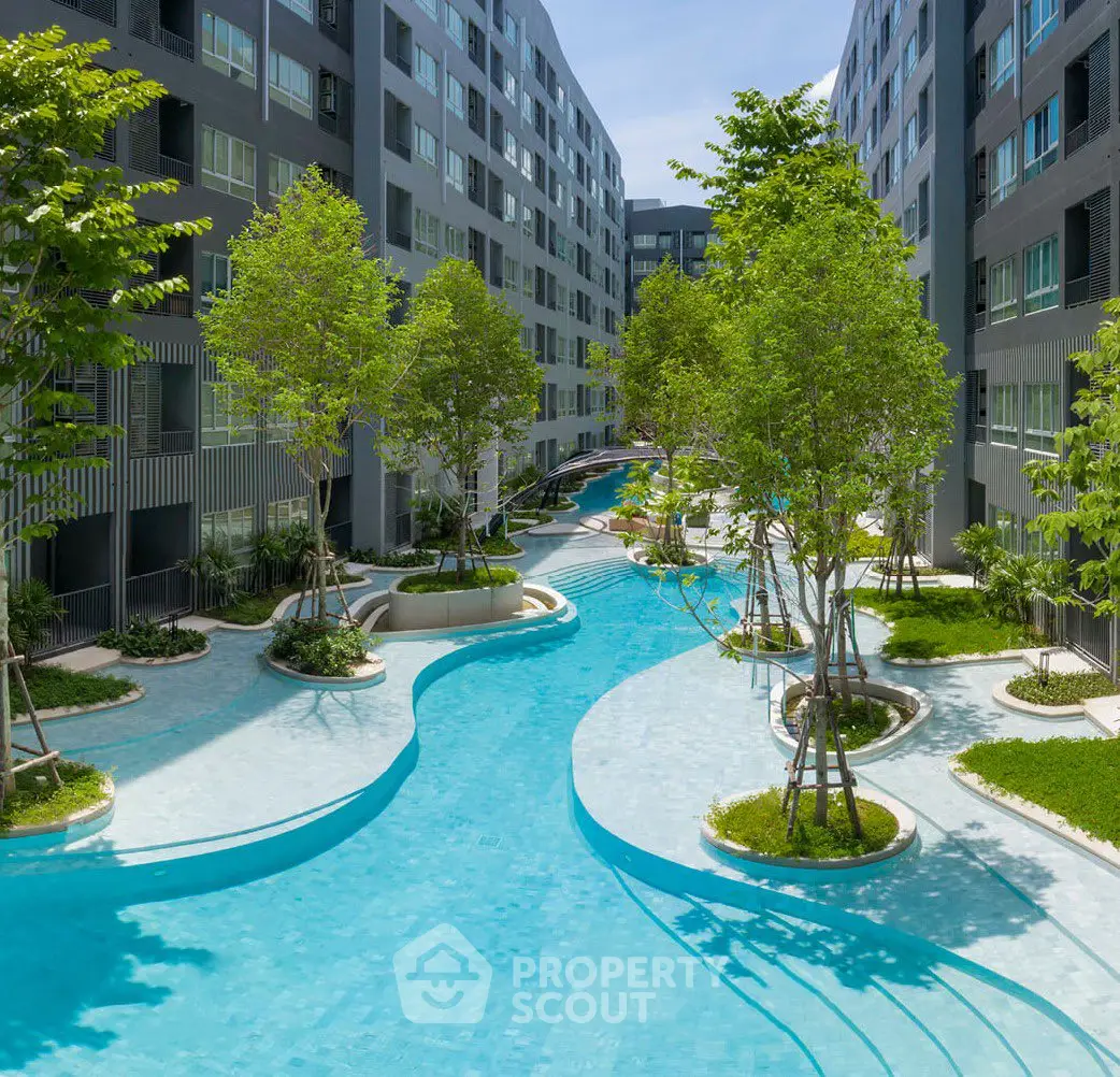 Luxurious residential complex with stunning pool and lush greenery