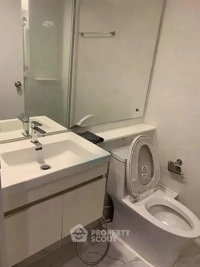 Modern bathroom with sleek fixtures and a glass shower enclosure, perfect for contemporary living.