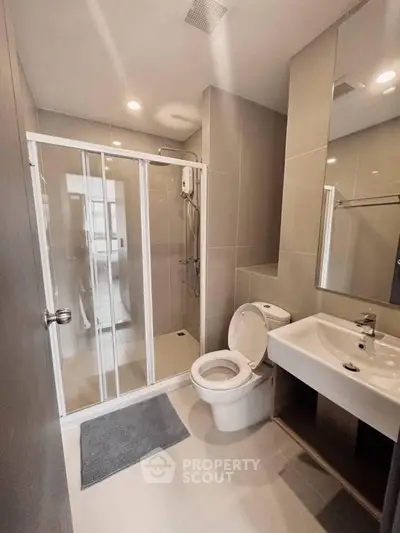 Modern bathroom with sleek shower enclosure and contemporary fixtures.