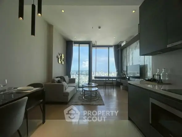 Modern living room with stunning city view, open kitchen layout, and elegant decor.
