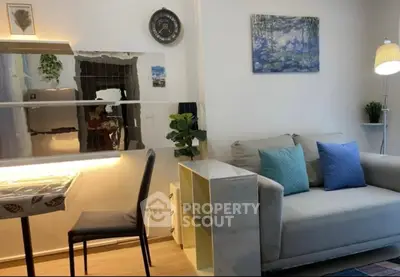 Charming living room with modern decor, cozy sofa, and stylish dining area, perfect for relaxation and entertaining.