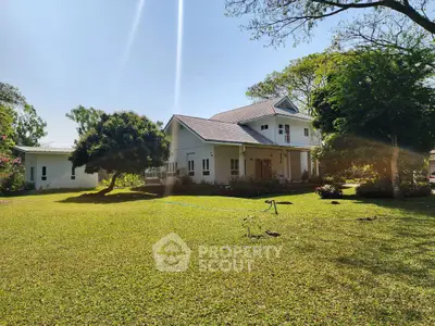 Charming suburban home with lush green lawn and mature trees, perfect for family living.