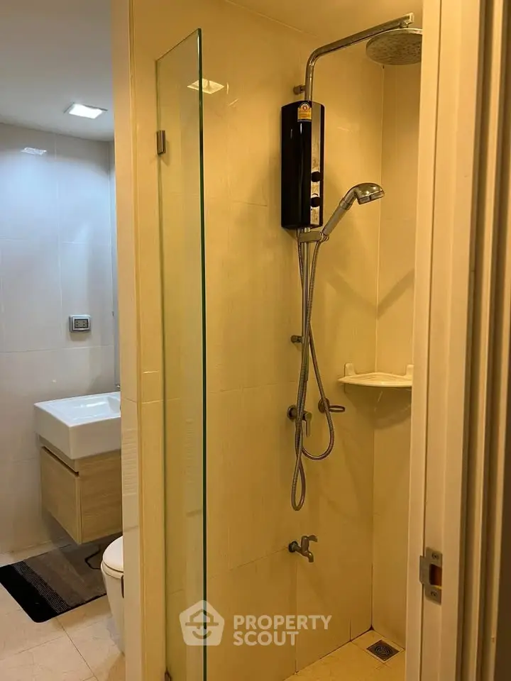 Modern bathroom with glass shower and sleek fixtures in a contemporary apartment.